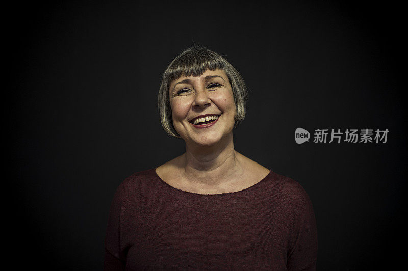 Senior Woman Posing Front of a Black Background